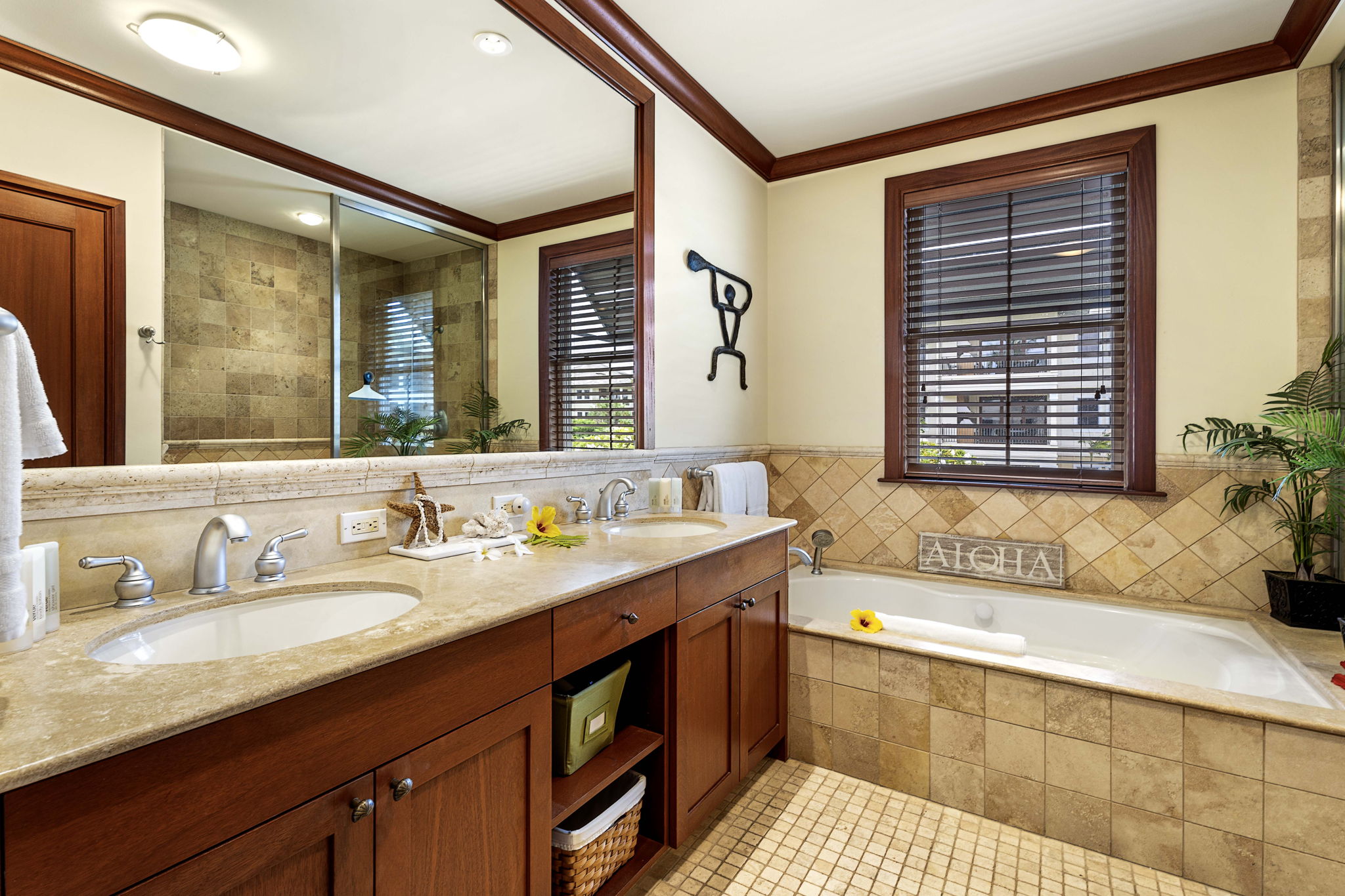 69-1000 Kolea Kai Circle, Unit 10B Waikoloa, HI 96738 - Photo 12 of 27 a bath room with a sink and a large mirror next to a window