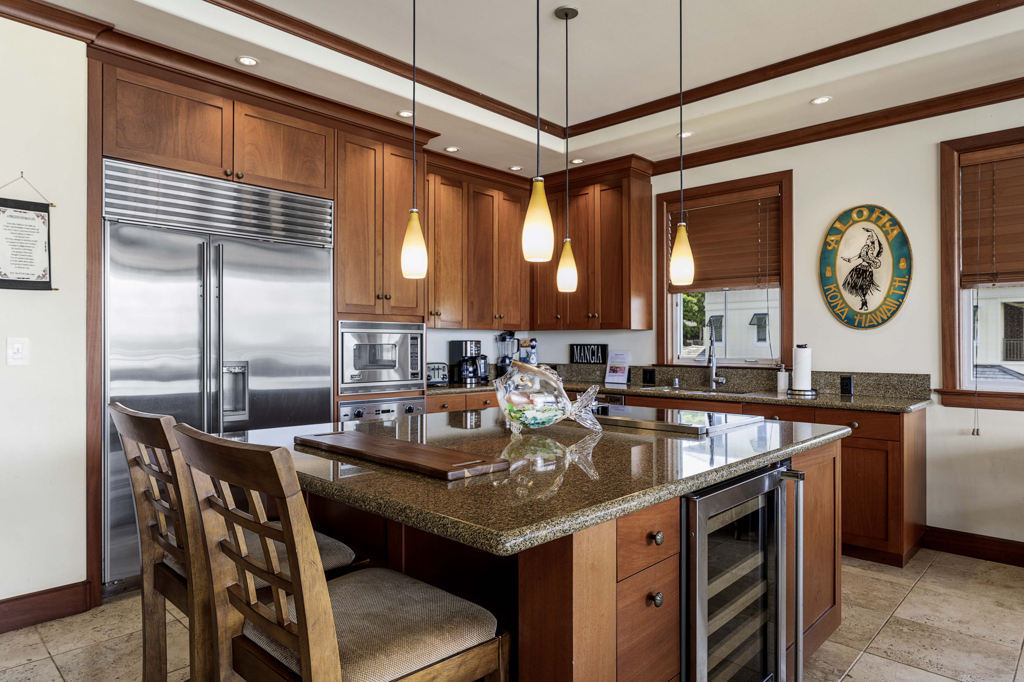 69-1000 Kolea Kai Circle, Unit 10B Waikoloa, HI 96738 - Photo 19 of 27 a kitchen with a stove a refrigerator and a dining table