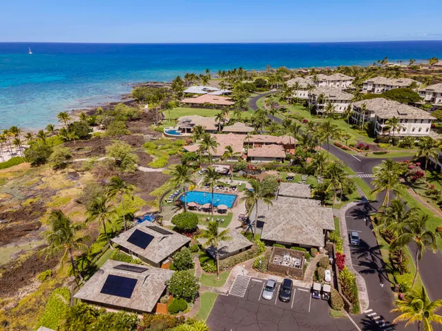 an aerial view of residential building with ocean view