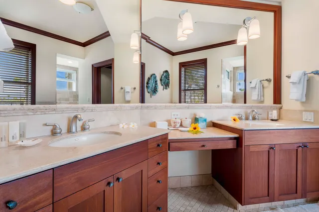a bathroom with a double vanity sink and a mirror
