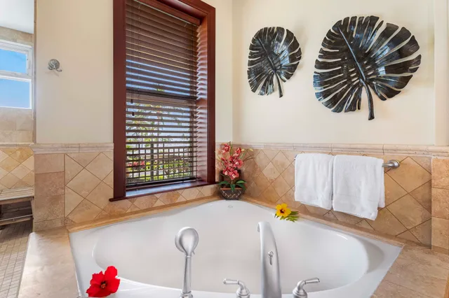 a view of bathroom with a tub and shower