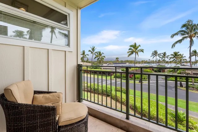 a balcony with table and chairs