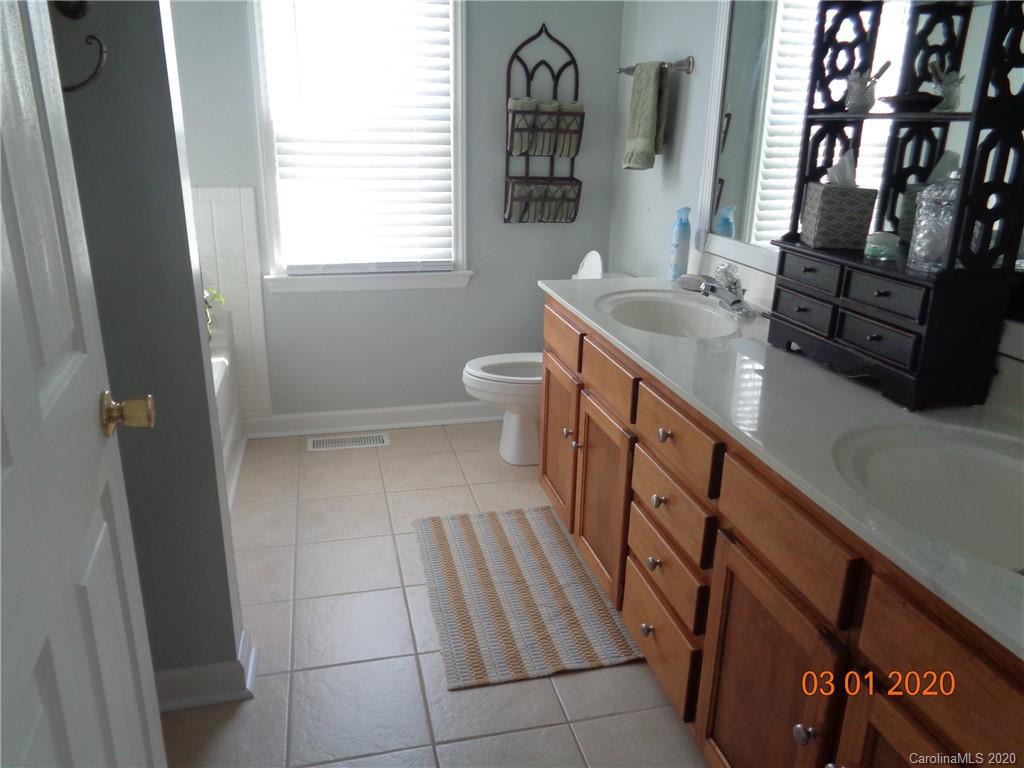 5422 Fish Road Marshville, NC 28103 - Photo 13 of 38 a bathroom with a sink a toilet and a mirror