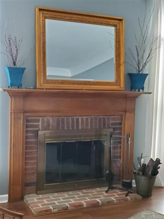 5422 Fish Road Marshville, NC 28103 - Photo 22 of 38 a front view of a fireplace with a potted plant