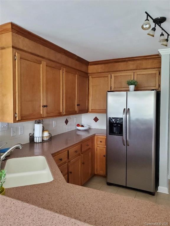 5422 Fish Road Marshville, NC 28103 - Photo 25 of 38 a kitchen with a sink refrigerator and cabinets