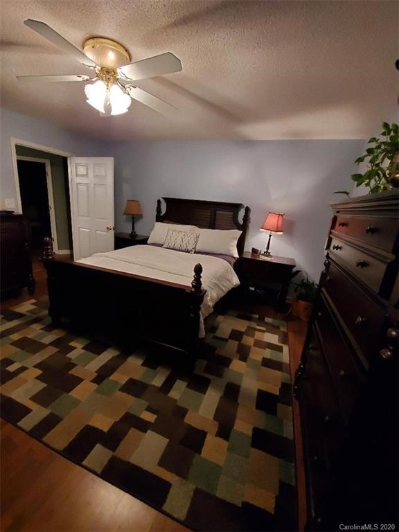 5422 Fish Road Marshville, NC 28103 - Photo 30 of 38 a bedroom with a bed and a chandelier