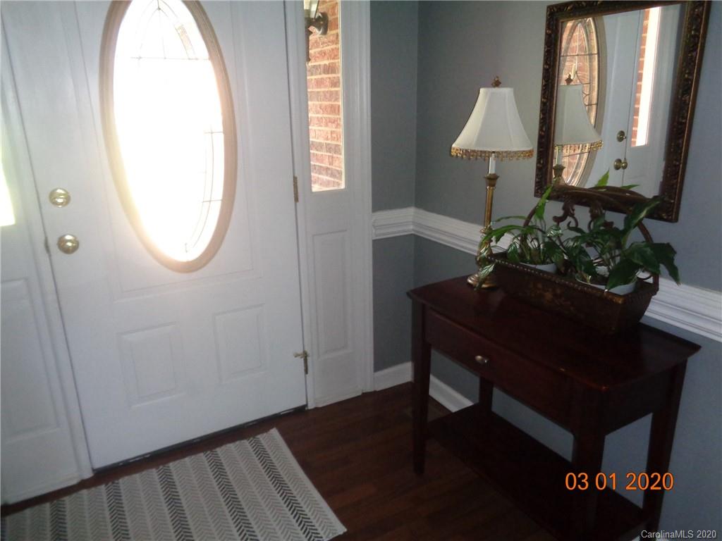 5422 Fish Road Marshville, NC 28103 - Photo 4 of 38 a room with painting on the wall and a mirror