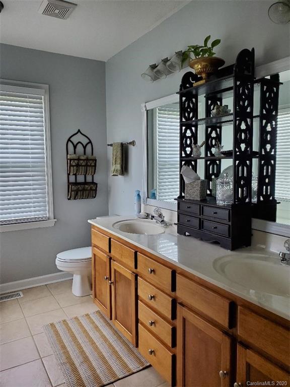 5422 Fish Road Marshville, NC 28103 - Photo 31 of 38 a bathroom with a toilet sink and mirror