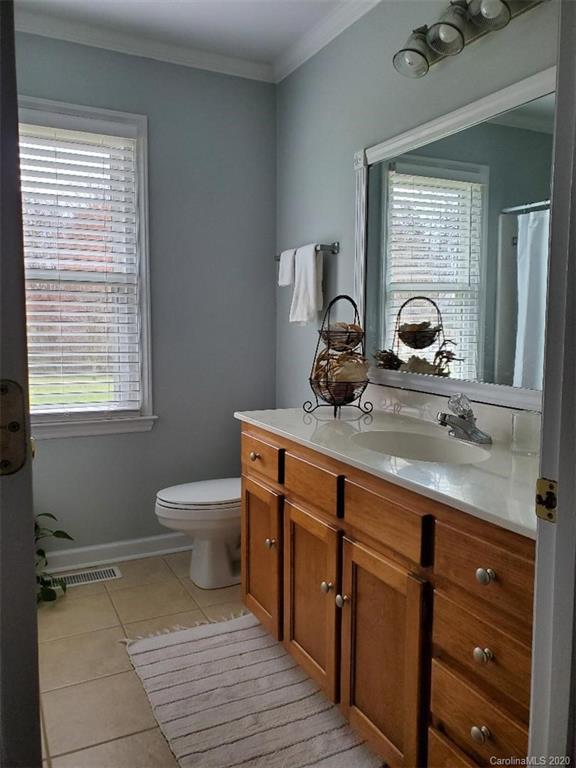 5422 Fish Road Marshville, NC 28103 - Photo 32 of 38 a bathroom with a toilet a sink and a window