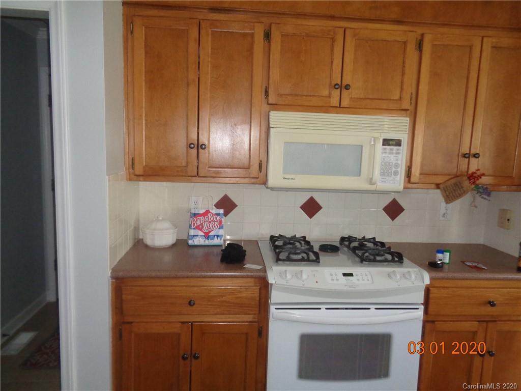 5422 Fish Road Marshville, NC 28103 - Photo 7 of 38 a kitchen with a stove and cabinets