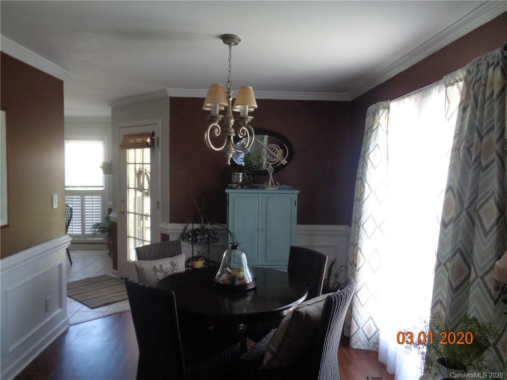 5422 Fish Road Marshville, NC 28103 - Photo 8 of 38 a view of a dining room with furniture wooden floor and chandelier