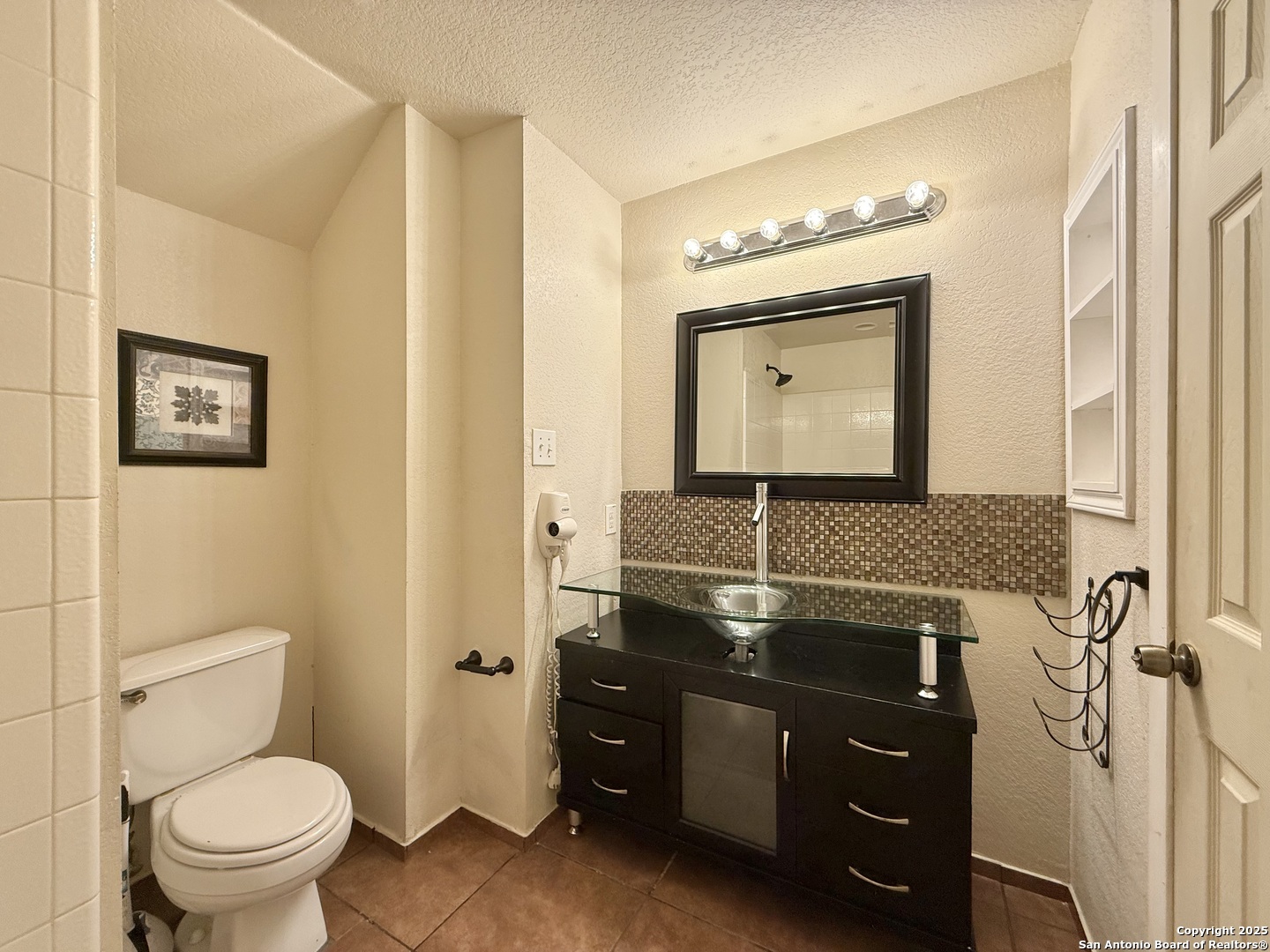 6118 Kensinger Pass Converse, TX 78109 - Photo 13 of 30 a bathroom with a toilet sink and mirror