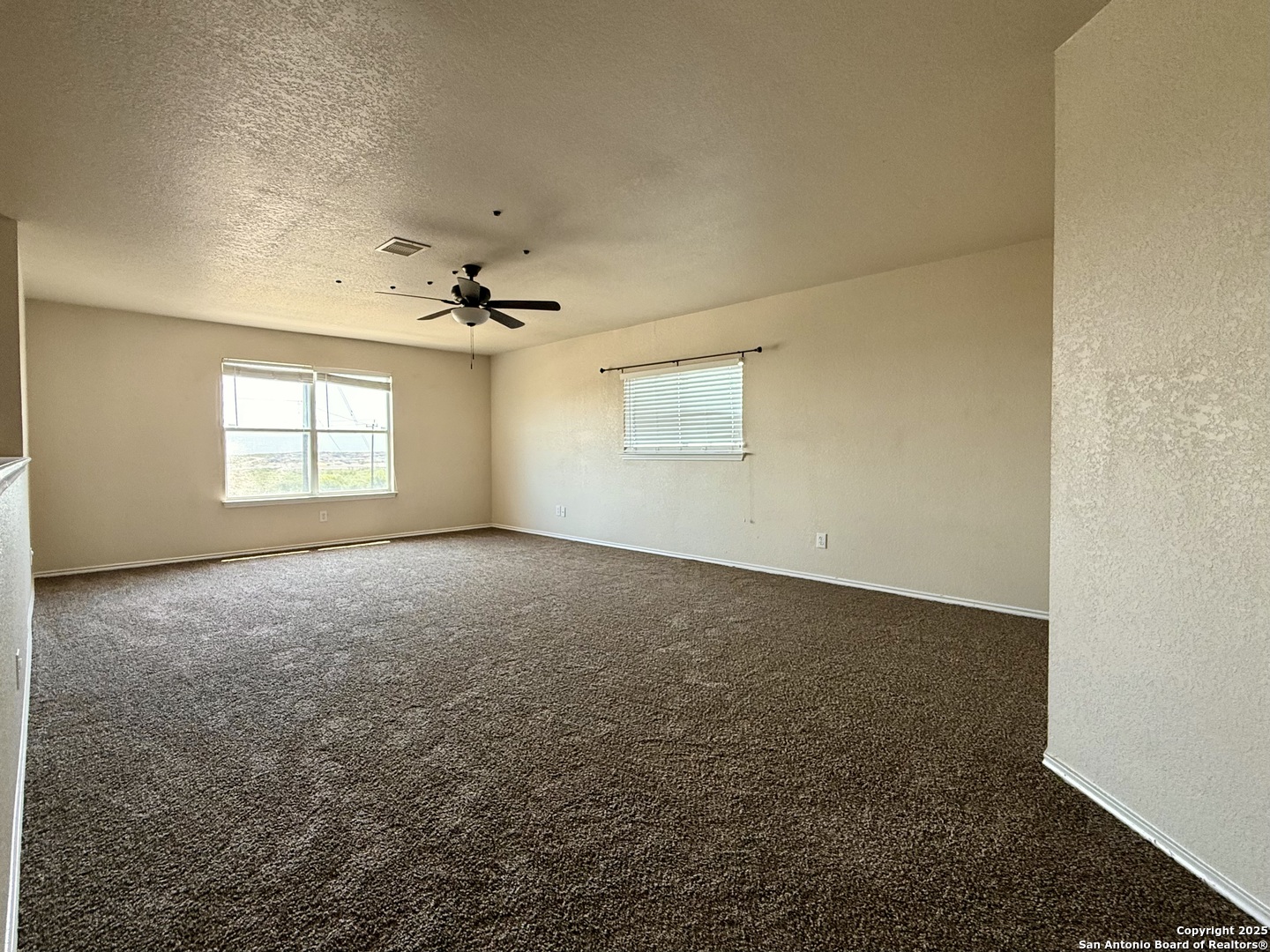 6118 Kensinger Pass Converse, TX 78109 - Photo 15 of 30 an empty room with a ceiling fan and window