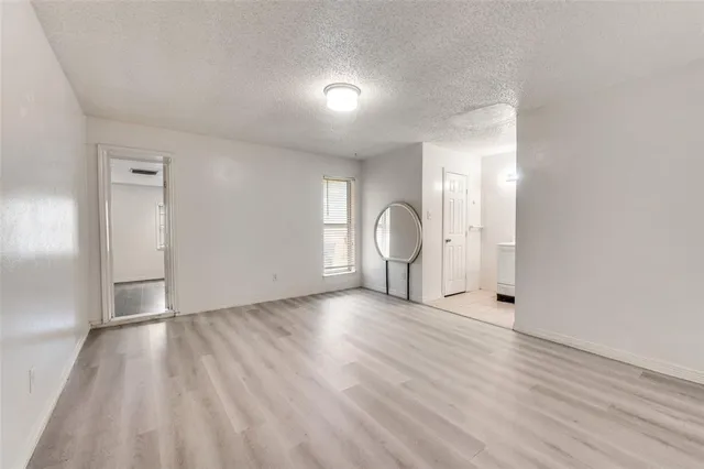 a view of a livingroom with wooden floor and window