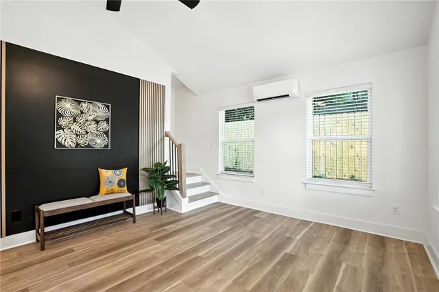 a wooden bench sitting in a living room next to a window
