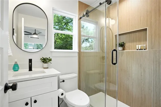 a bathroom with a sink a toilet and a mirror