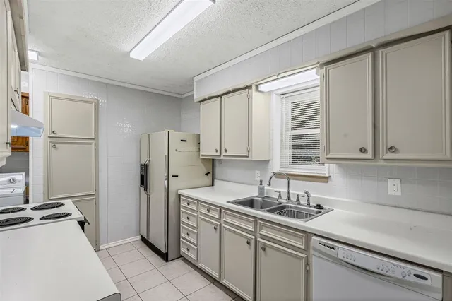 a kitchen with stainless steel appliances a sink stove and refrigerator