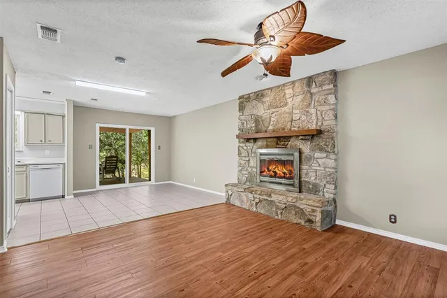 a view of an empty room with window and fireplace