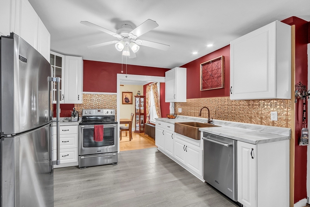 36 Mayfield Road Gardner, MA 01440 - Photo 10 of 35 a kitchen with stainless steel appliances kitchen island granite countertop a refrigerator a stove and a sink