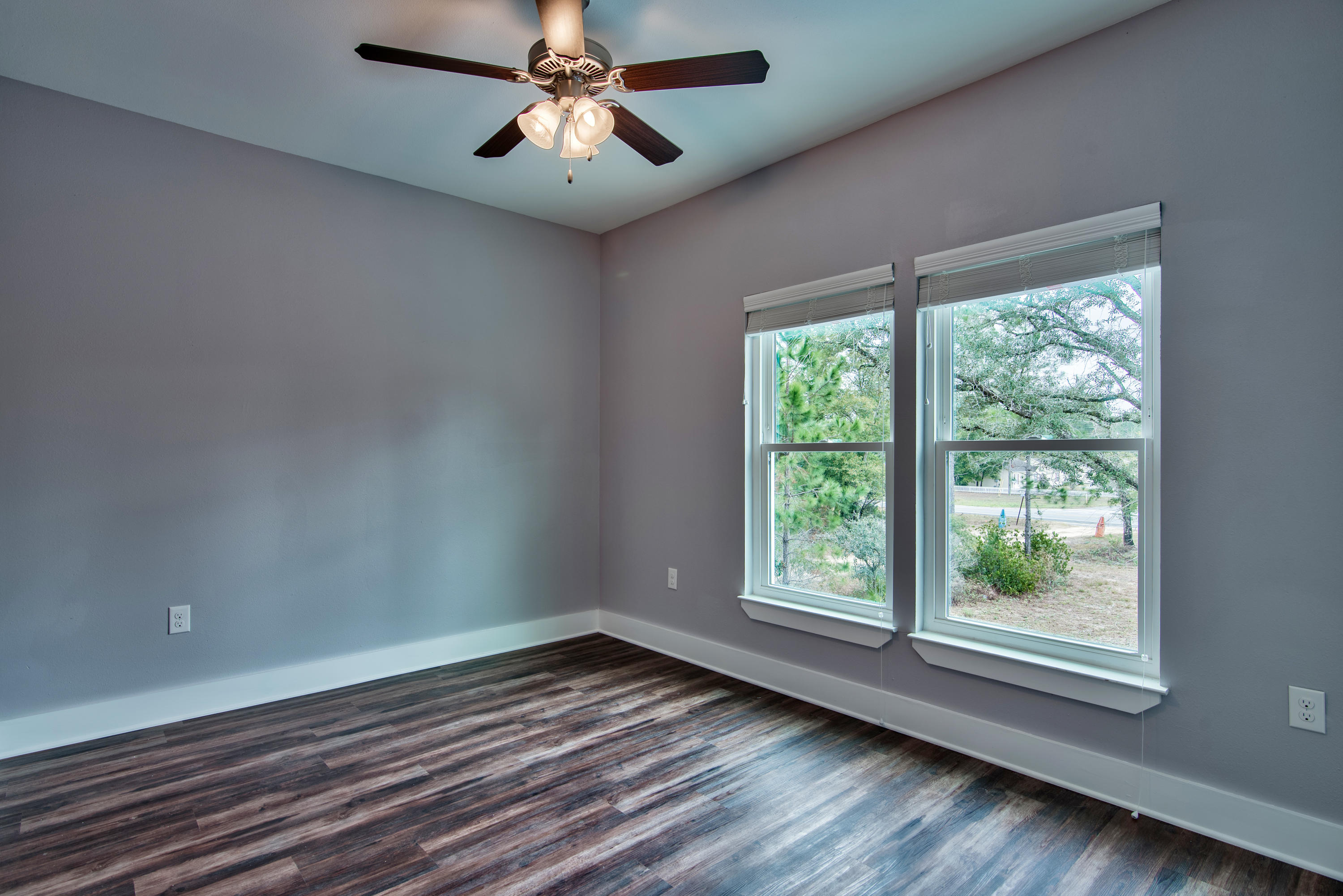 292 Date Palm Lane, Unit HORIZON Freeport, FL 32439 - Photo 19 of 32 a view of empty room with wooden floor and fan
