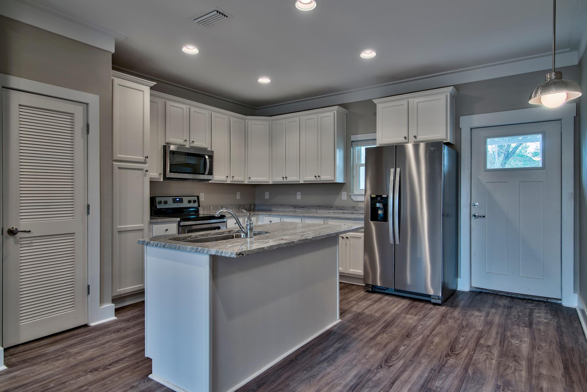 292 Date Palm Lane, Unit HORIZON Freeport, FL 32439 - Photo 4 of 32 a kitchen with a refrigerator a stove top oven and wooden floor
