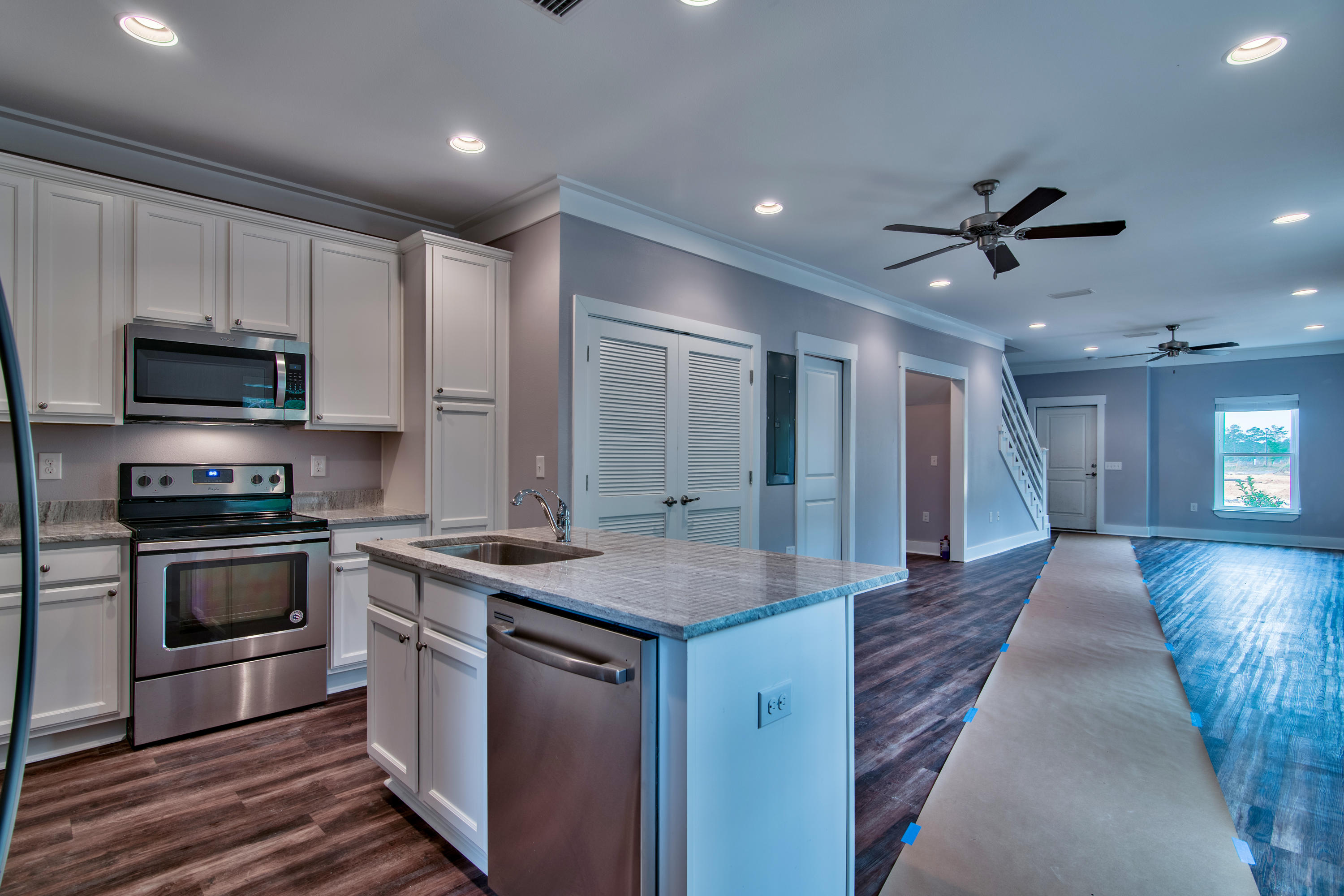292 Date Palm Lane, Unit HORIZON Freeport, FL 32439 - Photo 6 of 32 a kitchen with stainless steel appliances kitchen island granite countertop a stove and a sink
