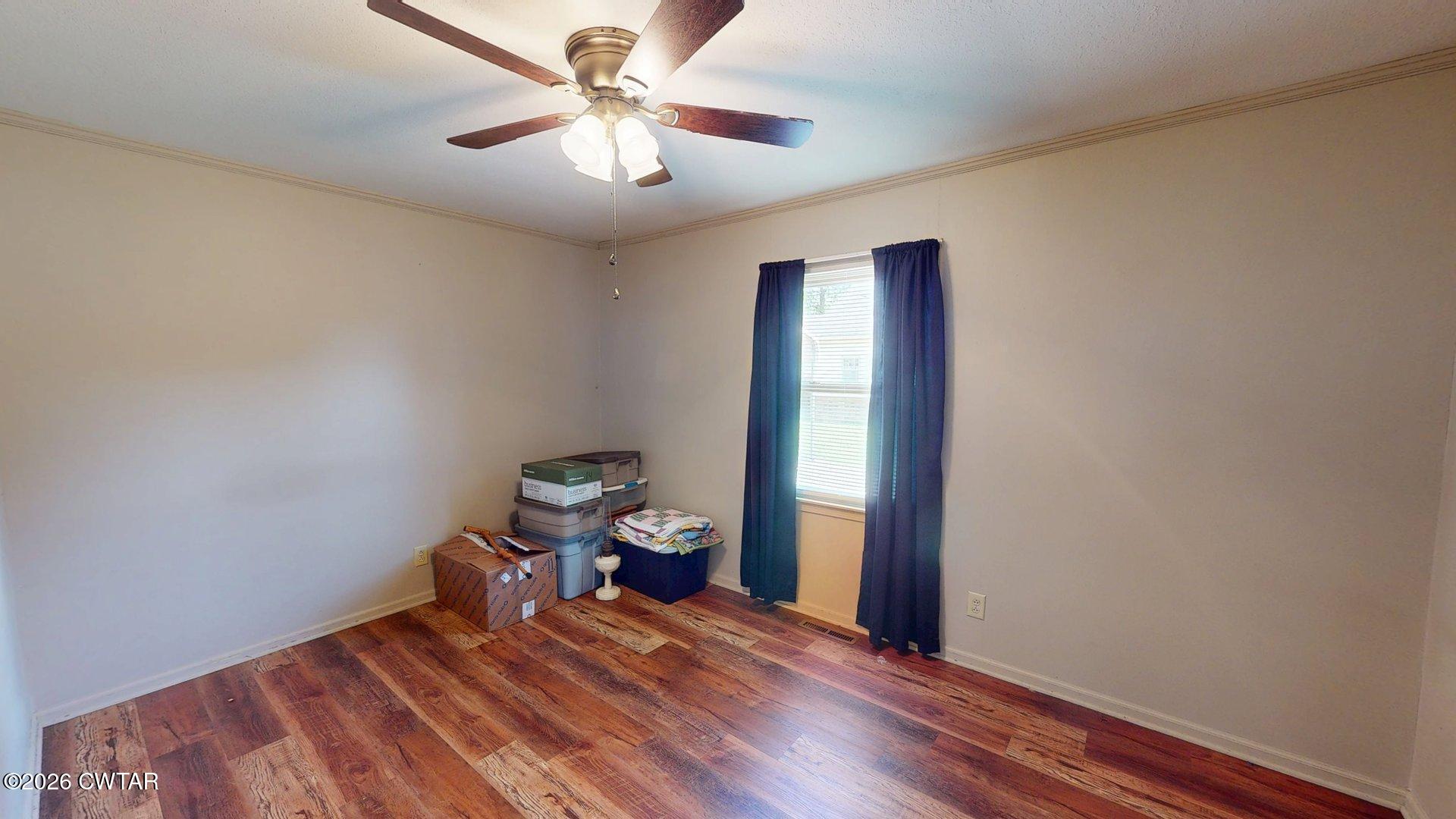 228 Lake Street Ridgely, TN 38080 - Photo 11 of 18 a bedroom with a bed and a chandelier