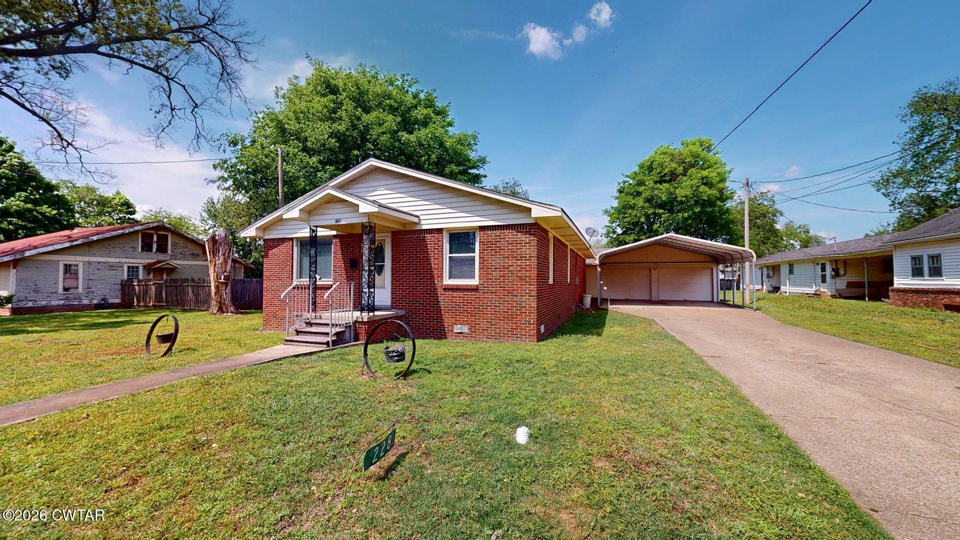 228 Lake Street Ridgely, TN 38080 - Photo 2 of 18 a front view of a house with garden