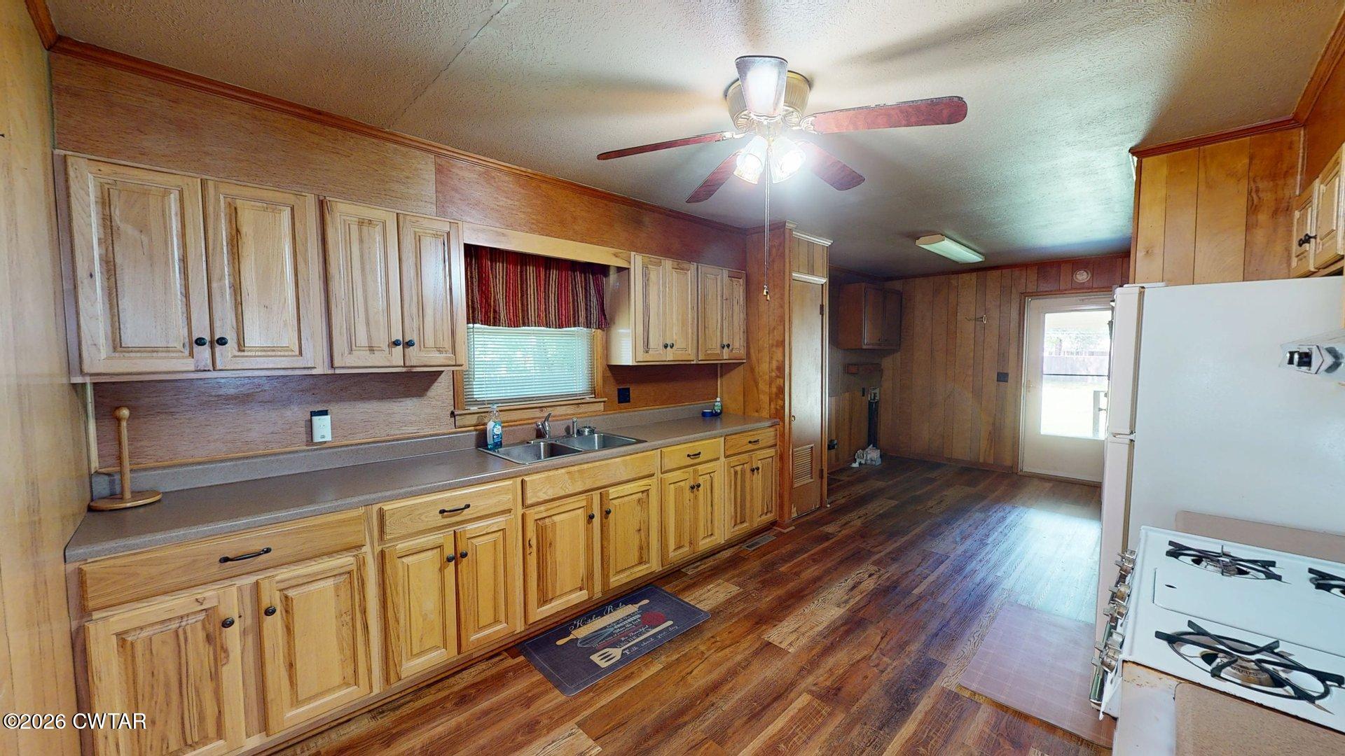 228 Lake Street Ridgely, TN 38080 - Photo 4 of 18 a kitchen with stainless steel appliances granite countertop a sink cabinets and wooden floor