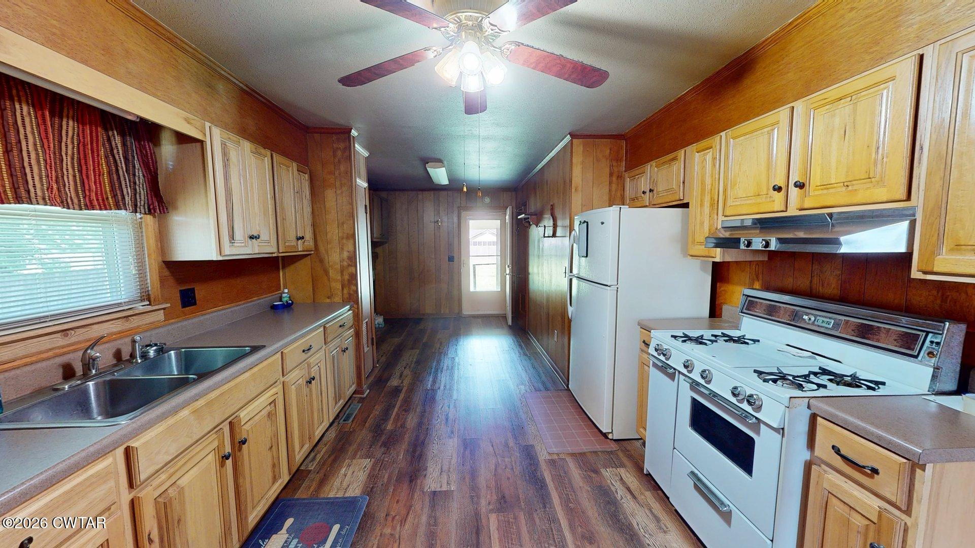 228 Lake Street Ridgely, TN 38080 - Photo 5 of 18 a kitchen with stainless steel appliances granite countertop a stove refrigerator and a view of living room