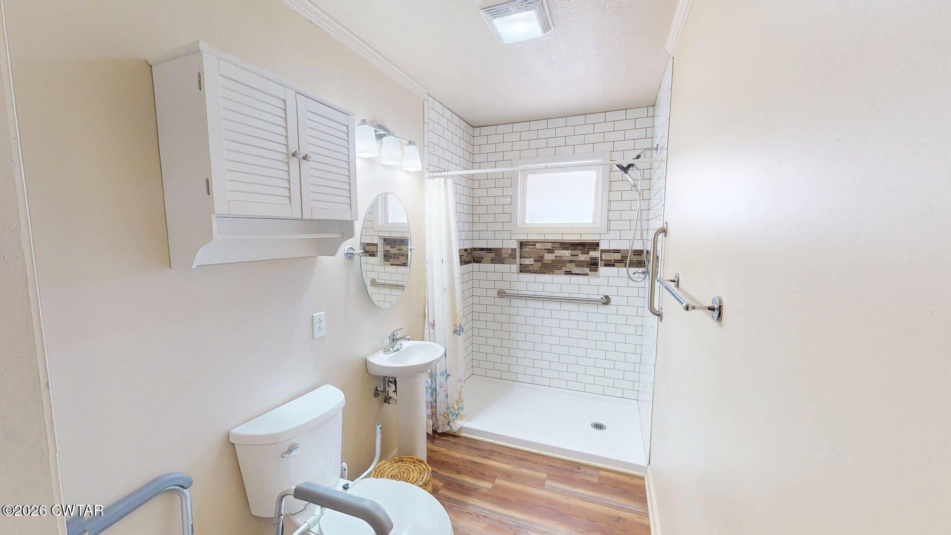 228 Lake Street Ridgely, TN 38080 - Photo 6 of 18 a bathroom with a toilet and a shower