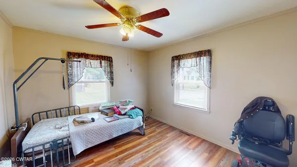a bedroom with furniture and a window