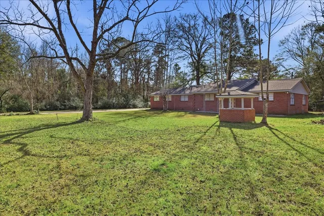 a garden with trees in front of it