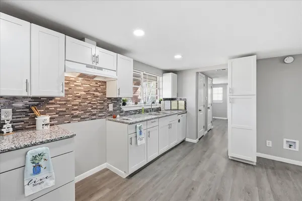 a kitchen with stainless steel appliances granite countertop refrigerator sink and cabinets