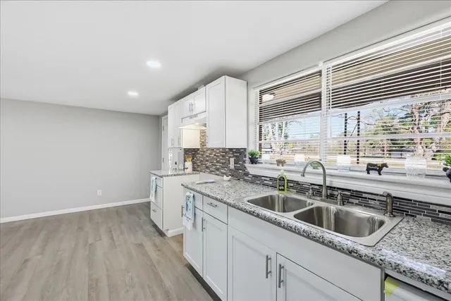 a kitchen with a sink cabinets and window