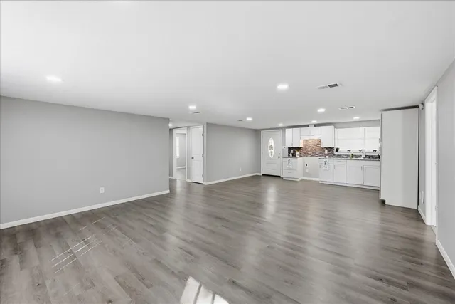 a view of an empty room and wooden floor
