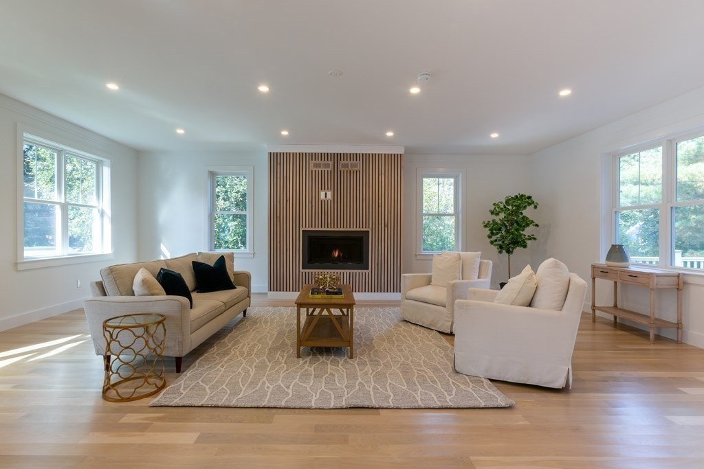 82 Border Road Needham, MA 02492 - Photo 4 of 8 a living room with furniture and a fireplace