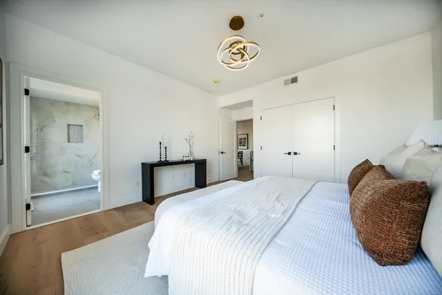 a bedroom with a bed and a chandelier