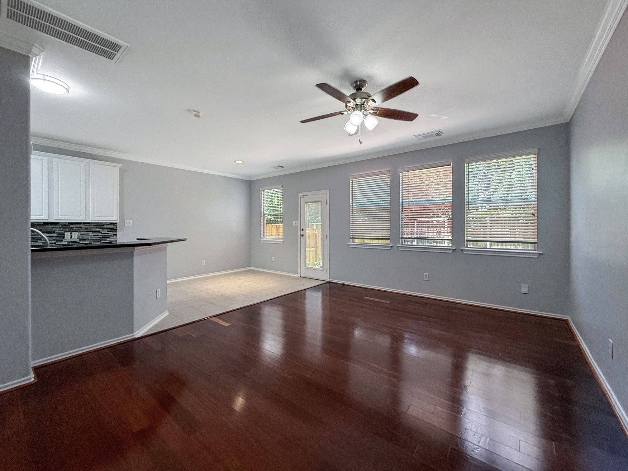3 Peach Ridge Place The Woodlands, TX 77382 - Photo 3 of 22 a view of an empty room with window and wooden floor