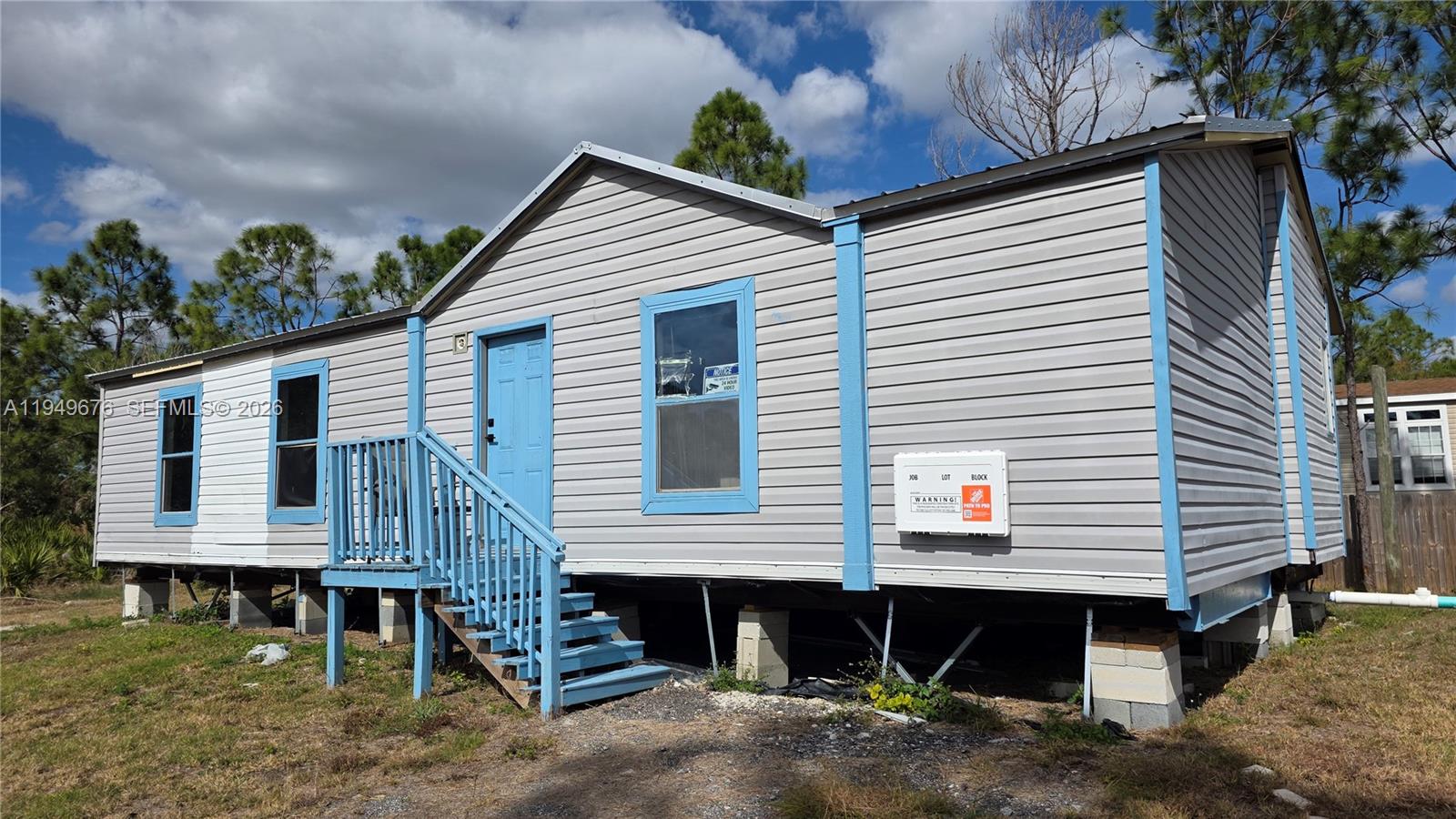 a view of a house with backyard and chairs