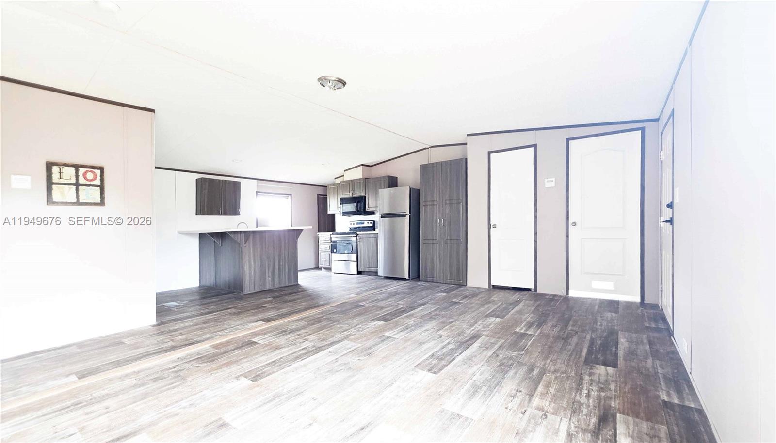 8357 Strasse Boulevard Punta Gorda, FL 33982 - Photo 18 of 37 a view of a kitchen with wooden floor and a refrigerator