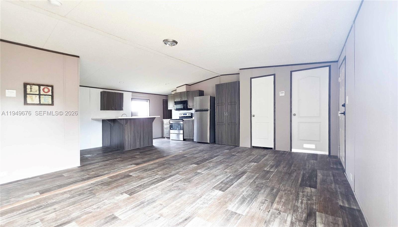 8357 Strasse Boulevard Punta Gorda, FL 33982 - Photo 19 of 37 a view of a kitchen with wooden floor and a refrigerator