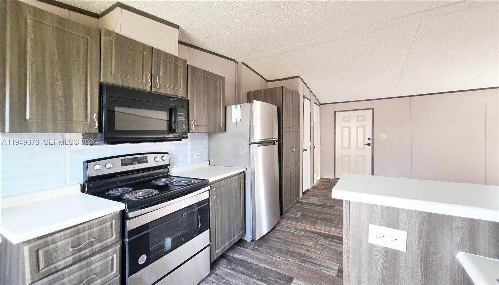 8357 Strasse Boulevard Punta Gorda, FL 33982 - Photo 22 of 37 a kitchen with a refrigerator stove and microwave