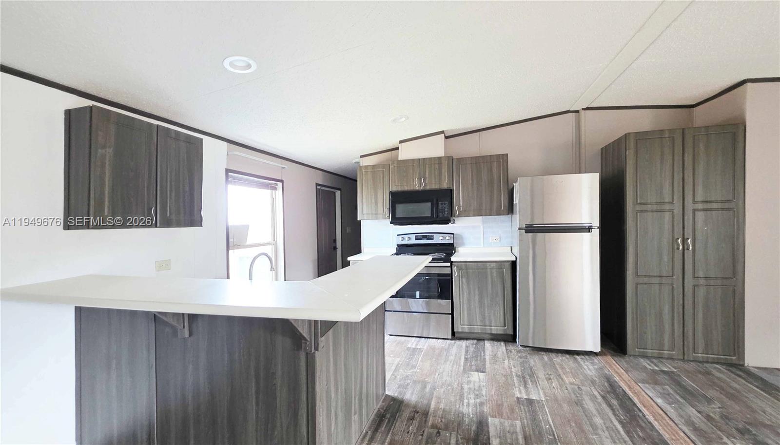 8357 Strasse Boulevard Punta Gorda, FL 33982 - Photo 25 of 37 a kitchen with stainless steel appliances a refrigerator sink and microwave