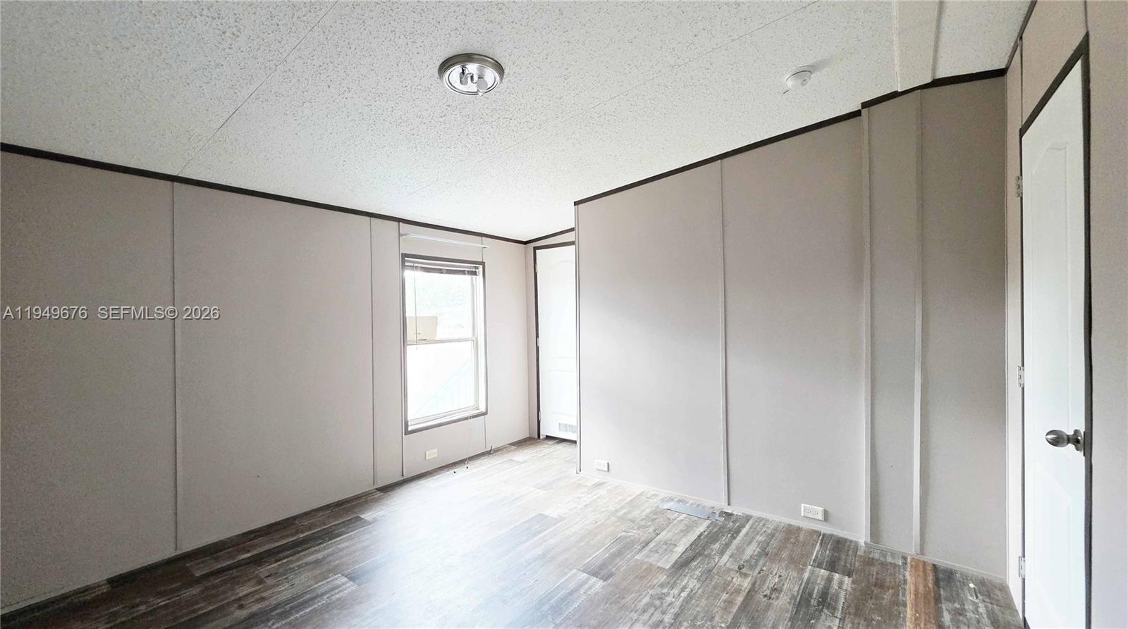 8357 Strasse Boulevard Punta Gorda, FL 33982 - Photo 33 of 37 a view of an empty room with closet and wooden floor