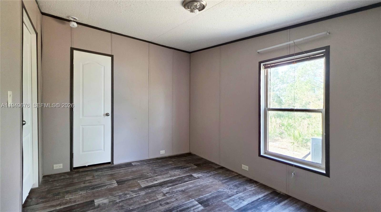 8357 Strasse Boulevard Punta Gorda, FL 33982 - Photo 34 of 37 a view of an empty room with wooden floor and a window