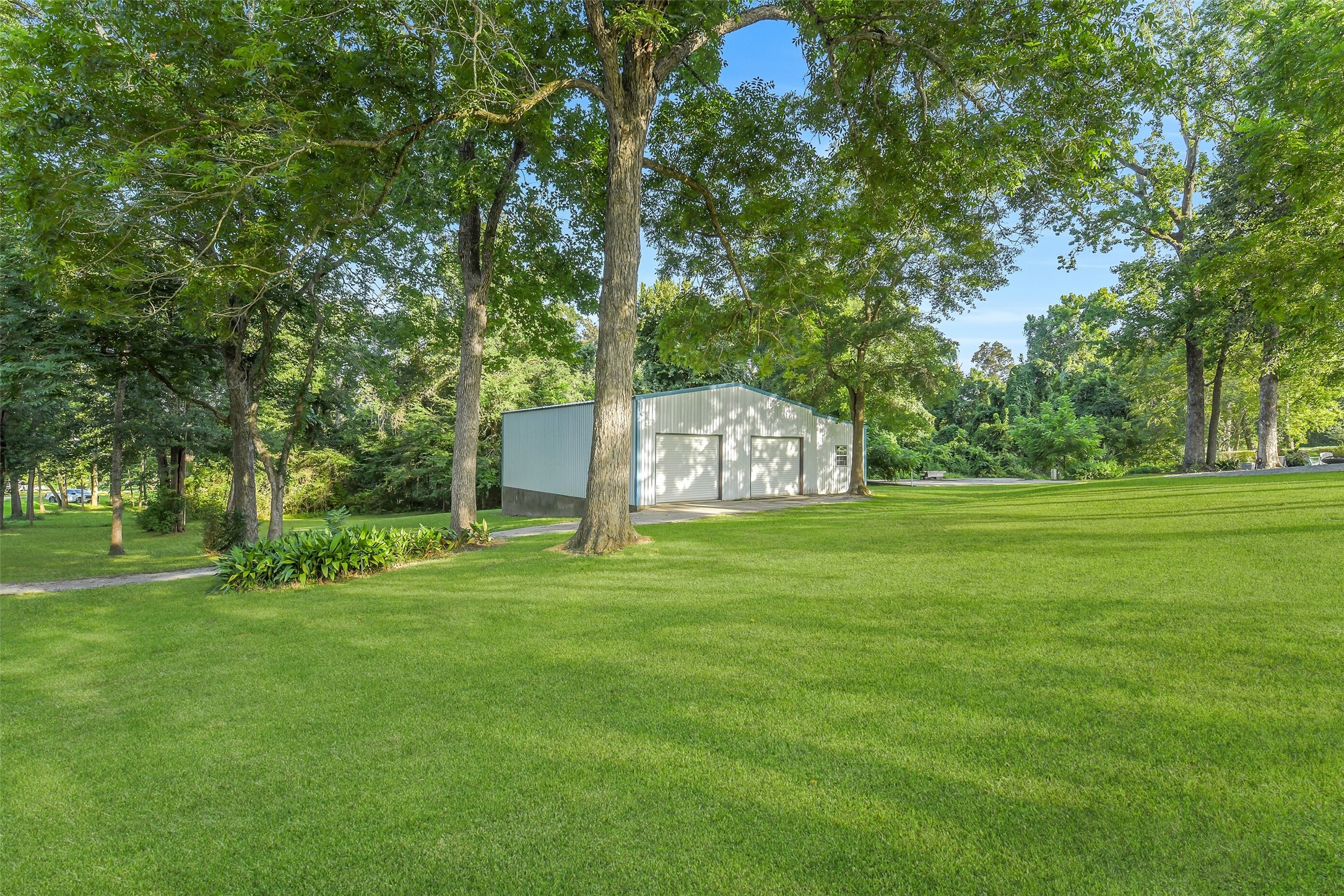 0 Camilla Lake Road Coldspring, TX 77331 - Photo 46 of 50 Metal Barn: Set among an expansive lawn and mature shade trees, the 1900+ sq ft metal barn provides an exceptional foundation for storage, workshop, creative or future conversion possibiities.