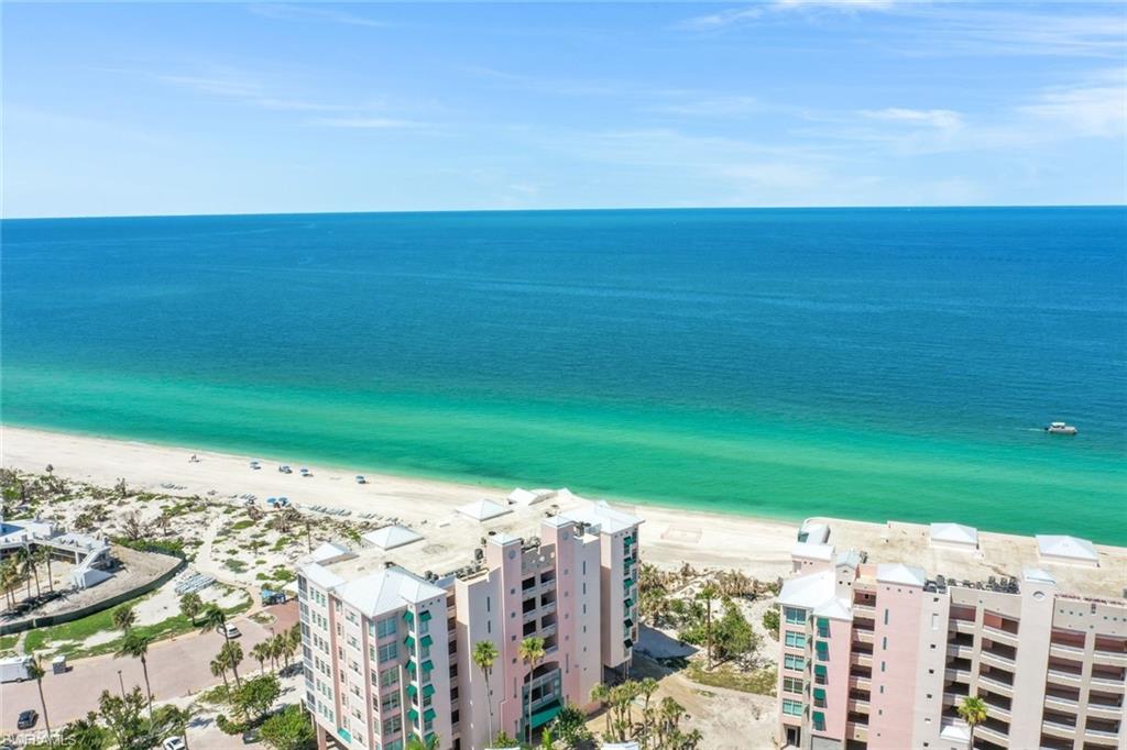 269 Barefoot Beach Boulevard, Unit 403 Bonita Springs, FL 34134 - Photo 23 of 27 Drone / aerial view of expansive beach and apartment complex / building