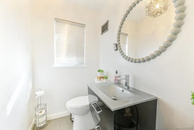 a bathroom with a sink a mirror and a toilet