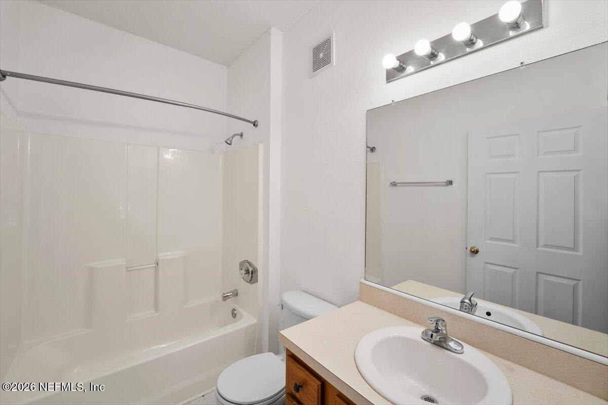 3641 Kirkpatrick Circle, Unit 141 Jacksonville, FL 32210 - Photo 14 of 25 a bathroom with a sink toilet and shower